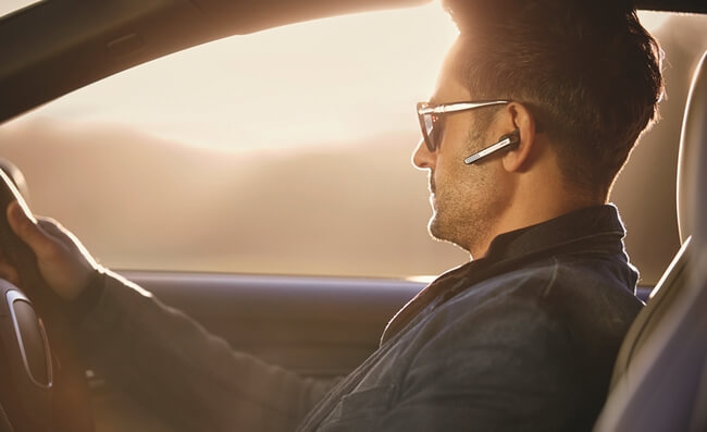 Are Bluetooth headsets safe: Man in car with Jabra Stealth headset